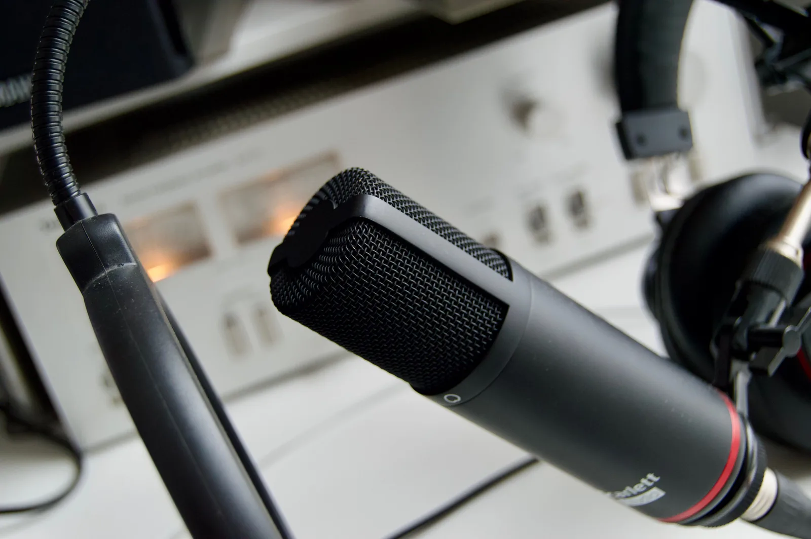 Close-up shot of a microphone in a studio setting, ideal for audio recording.